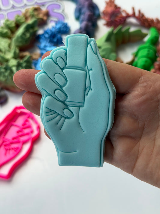 Saloon- hand holding Nail polish cutter + stamp